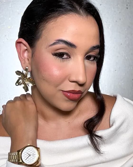 Jaqueline Ferreira com maquiagem sofisticada e acessórios dourados